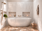 Freestanding bathtub with Nomad Just White Gloss wall tiles and Level Pebble Sepia Honed flooring.