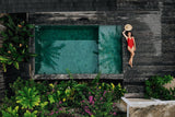 Biophilic pool design featuring Island Stone’s Sukabumi Select natural stone tiles