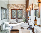 Spa bathroom with Island Stone pebble tile wall, freestanding tub, and natural wood accents creating biophilic sanctuary design
